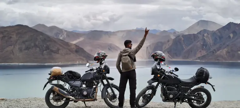 Ladakh motorcycle riders celebrating beside Pangong Lake